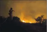  ?? COURTESY AMERICAN CANYON FIRE DEPARTMENT ?? An American Canyon firefighte­r, Donevin Steele, overlooks the Glass
Fire that has burned over 42,000 acres as of Tuesday afternoon.