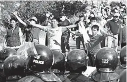  ?? VLADIMIR VORONIN/AP ?? Kyrgyz riot police block supporters of Almazbek Atambayev on Thursday near the former president’s residence near the capital, Bishkek. He was in office from 2011 to 2017.