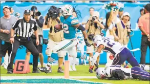  ?? Al Diaz / TNSjump ?? Kenyan Drake of the Dolphins scores the game-winning touchdown to defeat the Patriots on Sunday at Hard Rock Stadium in Miami Gardens, Fla.