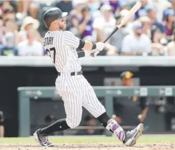  ?? Matthew Stockman, Getty Images ?? Rockies shortstop Trevor Story belts his 13th home run of the season during the sixth inning Sunday at Coors Field against the Pittsburgh Pirates.