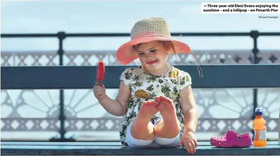  ?? Richard Swingler ?? > Three-year-old Eleni Evans enjoying the sunshine – and a lollipop – on Penarth Pier