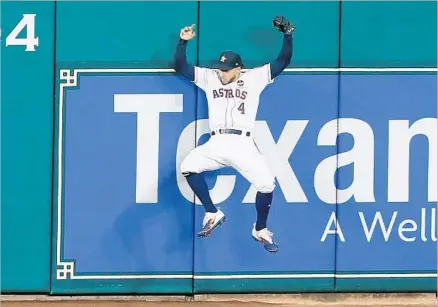  ?? Bob Levey Getty Images ?? WITH THE ASTROS leading 3-0 but two men on, George Springer robbed Todd Frazier of an extra-base hit in the seventh inning.