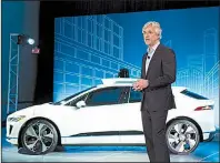  ?? AP/MARK LENNIHAN ?? John Krafcik, the chief executive officer of Waymo, stands with the Jaguar I-Pace vehicle last week in New York.