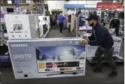  ?? THE ASSOCIATED PRESS ?? Flat-screen smart TVs are among the big-ticket items popular with consumers shopping for deals on Black Friday.