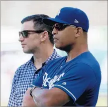  ?? Luis Sinco Los Angeles Times ?? ANDREW FRIEDMAN, left, with manager Dave Roberts, says the Dodgers will not try to force anything at the winter meetings.