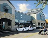  ?? AP/ERIC GAY ?? A shopper arrives at a Whole Foods Market in San Antonio earlier this month.