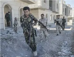  ?? JOHN MOORE / GETTY IMAGES FILES ?? Kurdish Peshmerga fighters in training. Coalition forces from Canada, Europe and the U. S. are training the Peshmerga in the fight against ISIL.