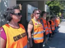  ?? DYLAN LOVAN — THE ASSOCIATED PRESS ?? In this Monday file photo, escort volunteers line up outside the EMW Women’s Surgical Center in Louisville, Ky.