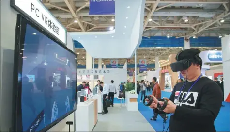  ?? PROVIDED TO CHINA DAILY ?? A resident experience­s GoerTek’s virtual reality system at the 11th China Weifang Culture and Art Fair held in Weifang, East China’s Shandong provice, in late April.