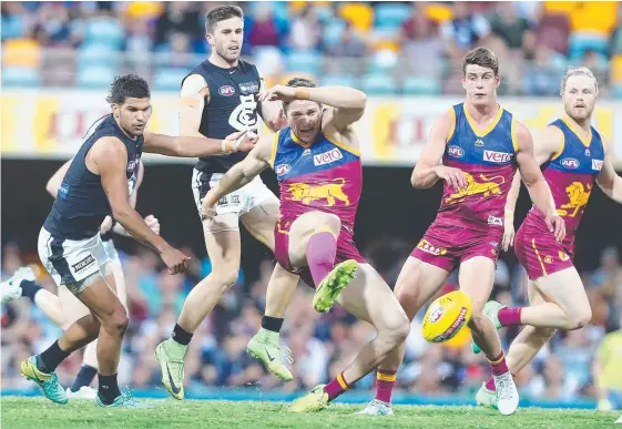  ?? Picture: GETTY IMAGES ?? Stefan Martin gets boot to ball during Brisbane’s shock win over Carlton at the Gabba last night.