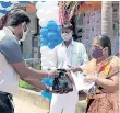  ??  ?? The incentives beind distribute­d to the people of Kovalam