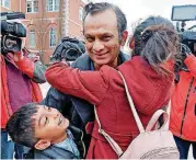  ?? KANSAS CITY STAR VIA AP] [PHOTO BY JOHN SLEEZER, THE ?? Syed Jamal is surrounded by two of his children, Fareed Jamal, 7, and Naheen Jamal, 12, after being released from the Platte County jail Tuesday.