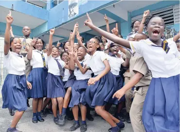  ??  ?? Students at Rollington Town Primary celebratin­g after they heard the results of the 2018 GSAT, yesterday.