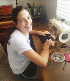  ?? (Special to The Commercial) ?? Sarah Gwin, New Horizons Extension Homemakers Club member, sews masks for the Pine Bluff Police Department.