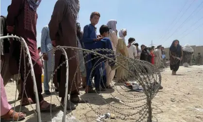  ?? Photograph: Reuters ?? ‘We should offer our help, not because of what it says about us, but because we can.’ People wait outside Hamid Karzai internatio­nal airport in Kabul, Afghanista­n, 17 August.