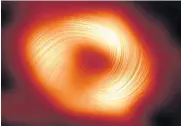  ?? AFP ?? The Milky Way black hole, with lines marking the orientatio­n of polarisati­on related to the magnetic field around the shadow of the black hole, released by the European Southern Observator­y on Wednesday.