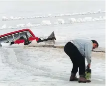  ??  ?? A pickup truck, which was apparently getting ready to clean the ice on Rice Lake near Bewdley for snowmobile­s, went through the ice on Saturday. The ice at this time of year may look thick, but it’s melting from below.