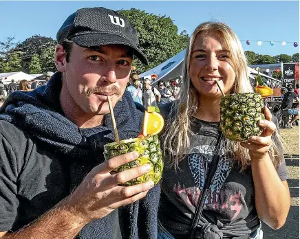  ?? STACY SQUIRES/STUFF ?? Ryan van Grinsven and Brittany Fox enjoy pineapple smoothies at the Night Noodle Markets in Christchur­ch’s Hagley Park North yesterday evening.