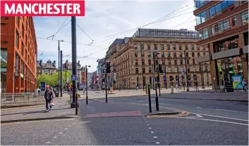  ?? ?? MANCHESTER
Deserted streets: The city centre’s lunchtime bustle is replaced with eerie silence