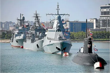  ?? AP ?? Warships go on parade during the Navy Day celebratio­n in Novorossiy­sk, Russia.