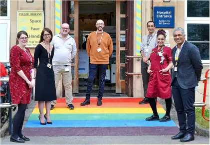  ?? ?? Members of the RUH executive team and LGBTQ+ Staff Network attend the opening of the rainbow entrance