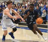  ?? (NWA Democrat-Gazette/J.T. Wampler) ?? JaJuan Boyd of Springdale Har-Ber drives to the basket while Derek Hobbs of Rogers defends in the Wildcats’ 62-53 victory over the Mounties on Tuesday night.