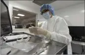  ?? MARK LENNIHAN — THE ASSOCIATED PRESS ?? A pharmacist labels syringes in a clean room where doses of COVID-19 vaccines will be handled at Mount Sinai Queens hospital in New York on Wednesday.