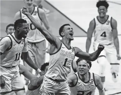  ?? MICHAEL CONROY/AP ?? Gonzaga guard Jalen Suggs (1) celebrates making the game winning basket against UCLA during overtime the men's Final Four on Saturday at Lucas Oil Stadium in Indianapol­is. Gonzaga won 93-90.