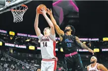  ?? LUCAS PELTIER/THE ASSOCIATED PRESS ?? Arizona center Motiejus Kris catches a rebound against Florida Atlantic’s Jalen Gaffney during Saturday’s Owls win in Las Vegas, Nev.