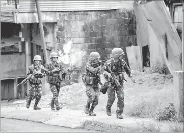  ?? — AFP photo ?? File photo shows Philippine Army Scout Rangers move positions during a mission to  ush out Islamist militant snipers in Marawi, on the southern island of Mindanao.