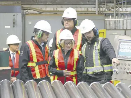  ?? JIM WELLS ?? Premier Rachel Notley speaks with company representa­tives during a tour on Friday of Tenaris, a manufactur­er and supplier of steel pipe products in south Calgary.