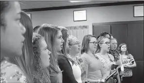  ??  ?? Mormon missionari­es sing at the North Little Rock stake office. The 182 members of the Arkansas Little Rock Mission will be giving a series of six concerts, also called musical devotional­s, throughout the mission beginning Sunday.