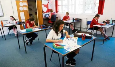  ??  ?? Playing safe:
Children keeping a safe distance from each other in a classroom at Watlington Primary school in Britain. — Reuters