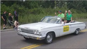  ?? KEITH REYNOLDS — THE MORNING JOURNAL ?? Toni and Gary Krone, two of the recipients of this year’s Golden Kernel Award, wave to spectators Aug. 11 as part of the parade on the final day of the North Ridgeville Corn Festival.