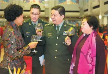  ?? FENG YONGBIN / CHINA DAILY ?? Minister of National Defense Chang Wanquan (second right), and his wife, Zhu Sanyi, toast the wife of Luckson Dziwika Phiri, defense attache at the Embassy of the Republic of Malawi, at a New Year reception held by the Ministry of National Defense in...