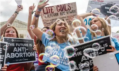  ?? Photograph: Brandon Bell/Getty Images ?? Anti-abortion activists celebrate in front of the supreme court after its ruling, on 24 June.
