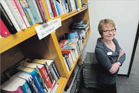  ?? MATHEW MCCARTHY WATERLOO REGION RECORD ?? Alannah d'Ailly, collection­s manager at the Waterloo Public Library, stands next to a shelf of books that were accidental­ly returned to the library’s main branch. If no one claims personal books, they’re considered donations.