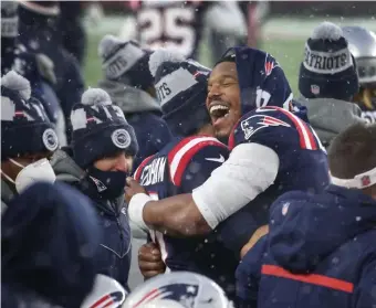  ?? NANCY LANE PHOTOS / HERALD STAFF ?? GREAT TEAMMATE: Cam Newton hugs Jarrett Stidham after the Patriots’ season came to a close with a 28-14 win over the Jets on Sunday at Gillette Stadium.