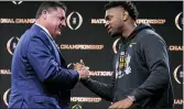  ?? DAVID J. PHILLIP — THE ASSOCIATED PRESS ?? LSU head coach Ed Orgeron, left, greets linebacker Patrick Queen after a news conference Tuesday in New Orleans.