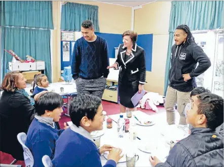  ??  ?? Big turnout: Hurricane Ardie Savea, left and All Black Ma’a Nonu, Maori Party co-leader Marama Fox, seated left, and Social Developmen­t Minister Anne Tolley celebrated the KickStart breakfast programme at Holy Family School.