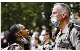  ?? STAR TRIBUNE VIA AP
MARK VANCLEAVE/ ?? A woman yells at a sheriff’s deputy during a protest Thursday in Minneapoli­s.