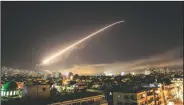  ?? AP/HASSAN AMMAR ?? Damascus’ sky lights up Saturday with surface-to-air missile fire as the U.S. launches an attack on Syria targeting different parts of Damascus. Syria’s capital has been rocked by loud explosions as President Donald Trump announced airstrikes in...