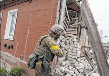  ?? Mstyslav Chernov The Associated Press ?? A Ukrainian serviceman patrols during a reconnaiss­ance mission Saturday in a recently retaken village on the outskirts of Kharkiv, in eastern Ukraine.