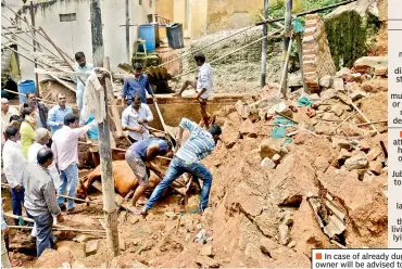  ?? —DC ?? Residents work to remove the corpse of a cow which was killed when a wall collapsed at Punjagutta.