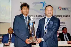  ?? ?? Rasith Wickramasi­ngha of CBL presenting the Best Athletes awards (Girls and Boys) to athletic captains of Gateway – Sithuli Saparamadu and Inas Iqbal
