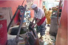  ?? — AFP ?? Shakeel Ahmad fills up a goat hide canteen from a well in New Delhi.