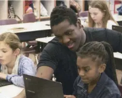  ?? Photo: Nebo School District ?? A Nebo District High School student helps an elementary student with coding as part of the STEM Ambassador­s program.