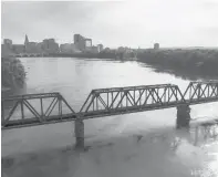  ?? MARK MIRKO/HARTFORD COURANT ?? A railroad bridge spans the Connecticu­t River between East Hartford and Hartford. The Riverwalk will extend from Hartford to the Windsor town line, not far from the waterfront.