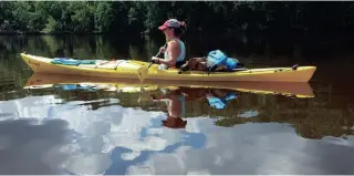  ?? COURTNEY LAMM ?? Milwaukee JournalSen­tinel reporter Chelsey Lewis kayaks theSt. Croix River on Wisconsin's western border.