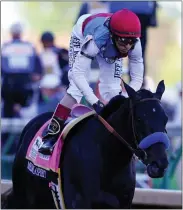  ?? ASSOCIATED PRESS FILE PHOTO ?? John Velazquez rides Medina Spirit to victory in the Kentucky Derby May 1. The Horse died after collapsing while working out at Santa Anita Park in Arcadia, Calif.